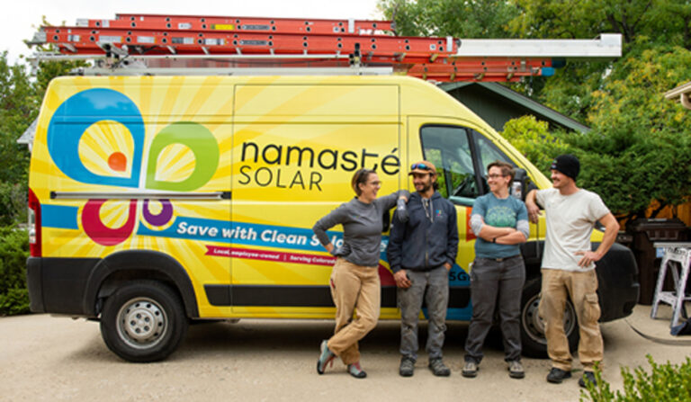 people standing in front of solar work truck