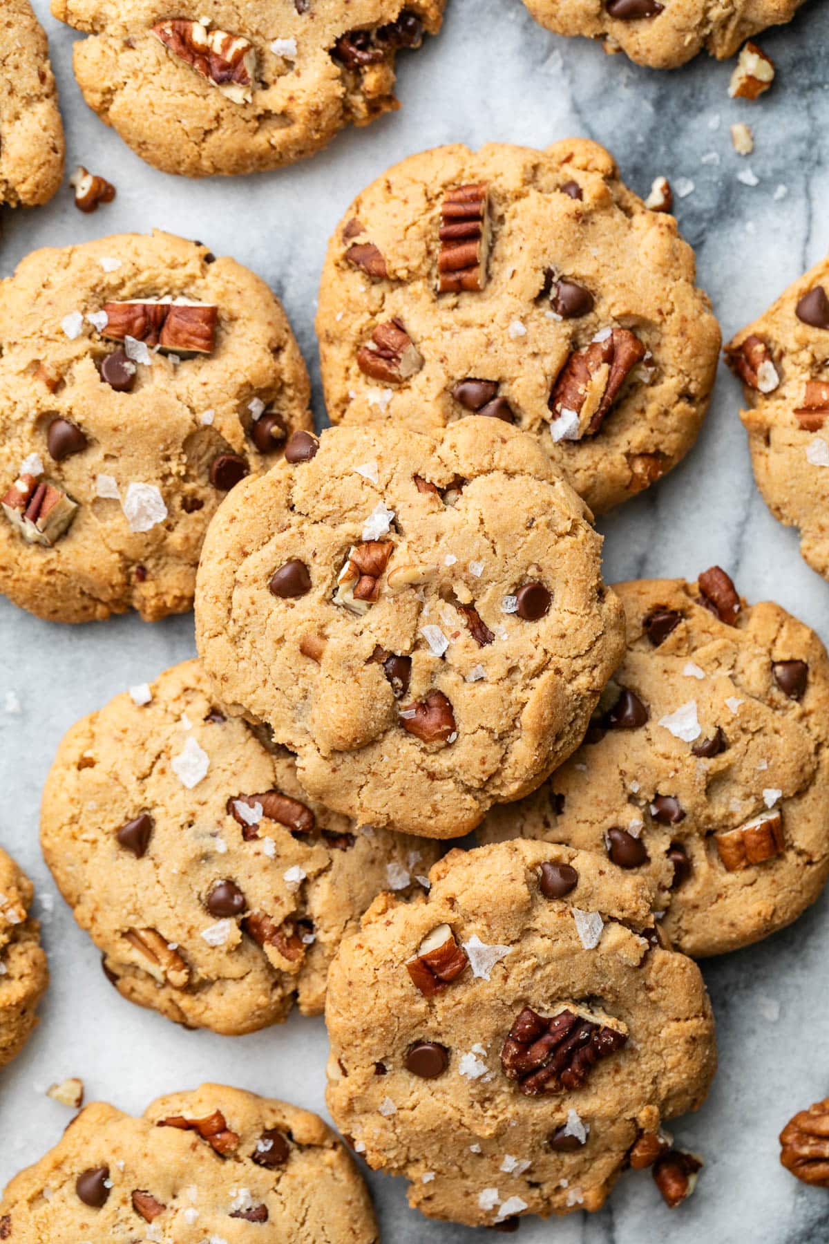 top down view of almond flour pecan sandies arranged on a marble slab.
