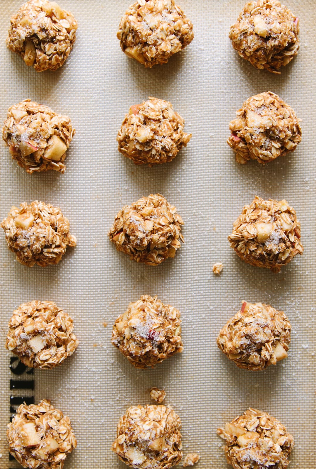 top down view of apple oatmeal breakfast cookies on a baking sheet ready for the oven.