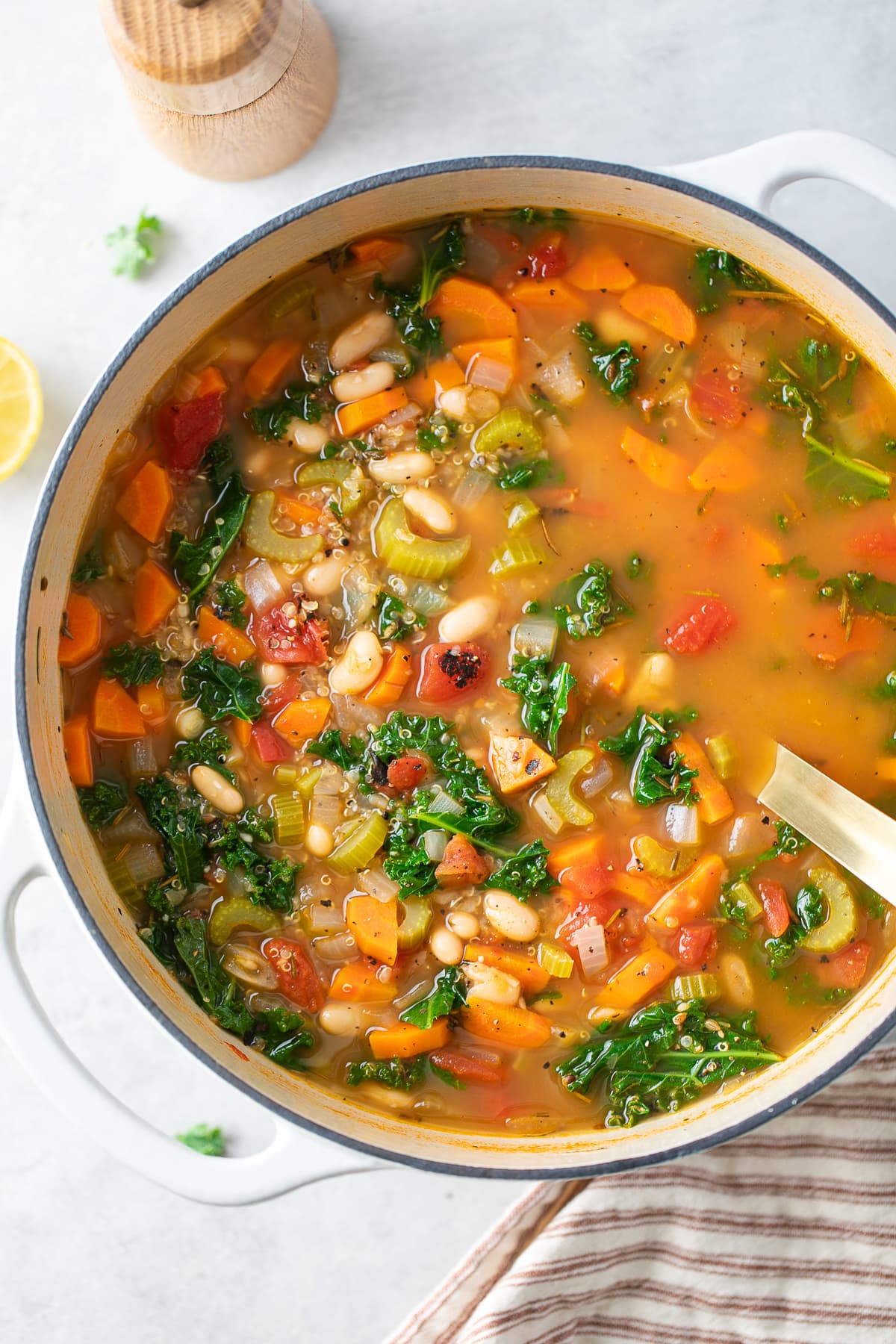 top down view of freshly made pot of healthy kale, quinoa, and white bean soup.