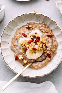 top down view of bowl with banana overnight steel cut oats with items surrounding.