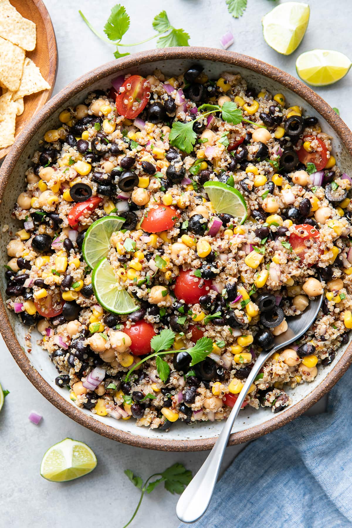 top down view of freshly made southwest quinoa salad in a serving bowl with spoon.