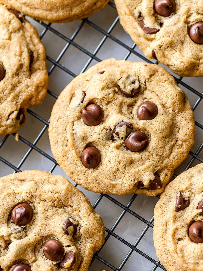 top down view of group of vegan chocolate chip cookies on a wire rack.