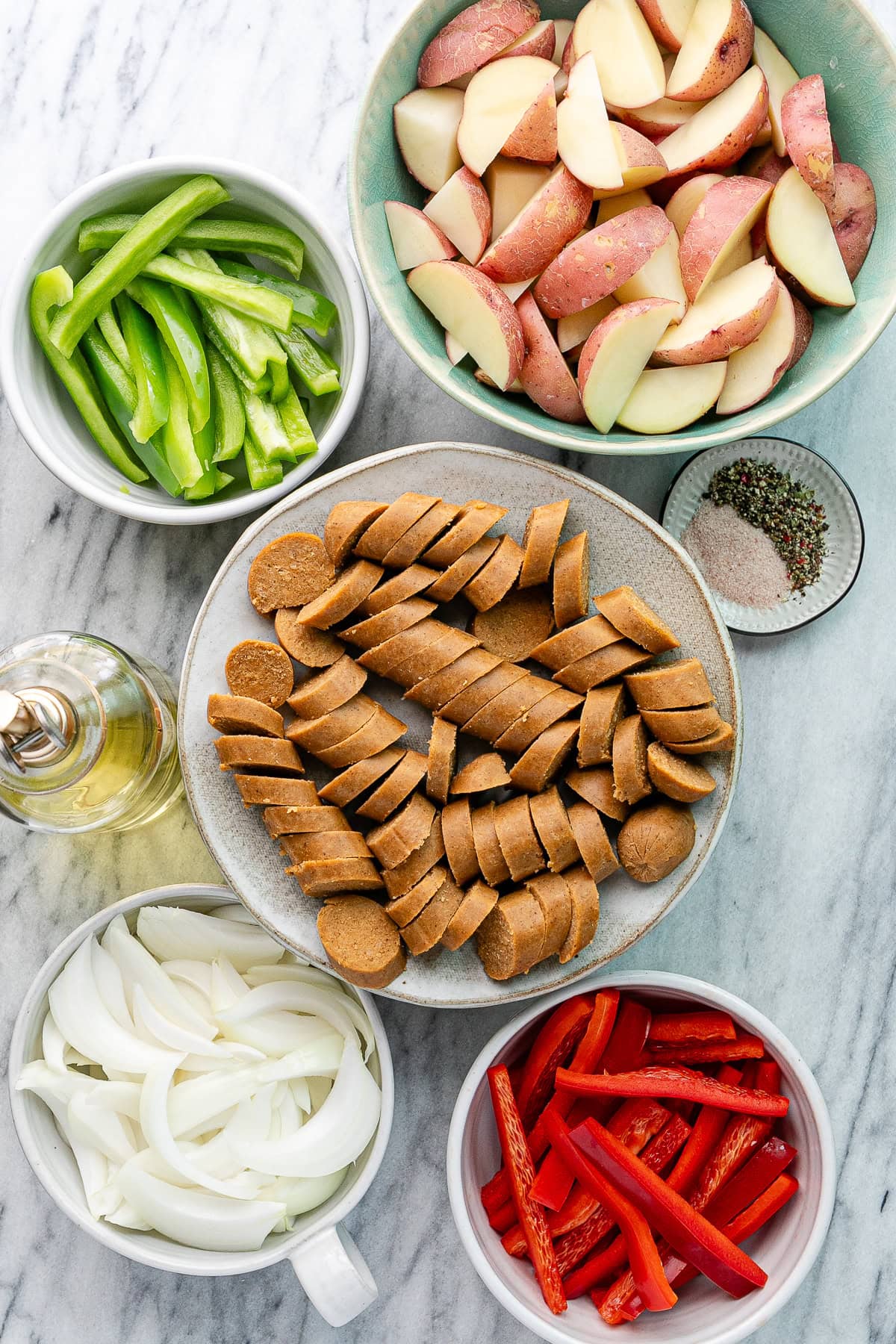 top down view of ingredients used to make vegan kielbasa sausage with potatoes and peppers recipe.