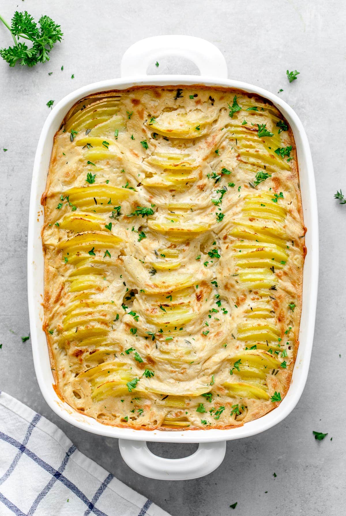 top down view of baking dish with freshly made vegan scalloped potatoes.