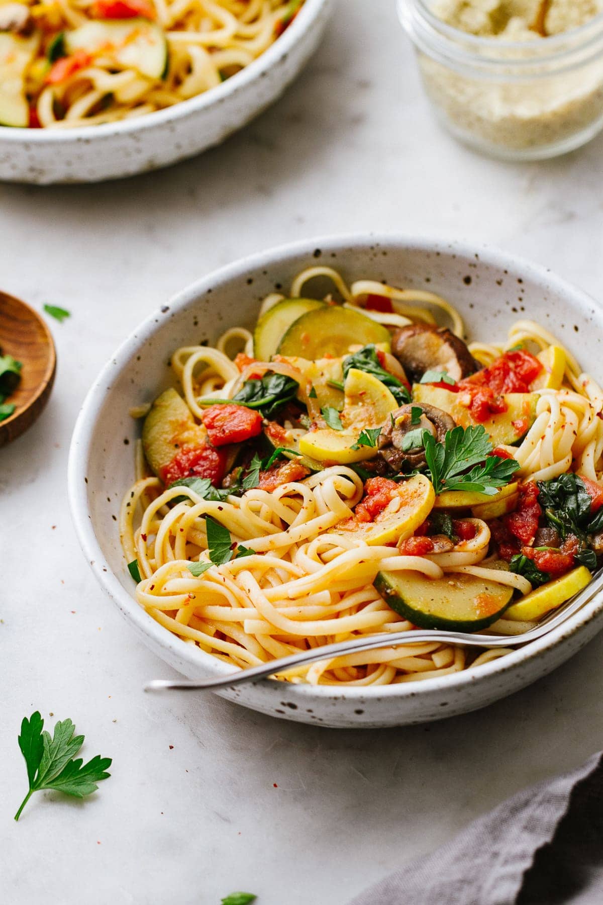 side angle view of a bowl with a serving of the best vegetable spaghetti with fork.