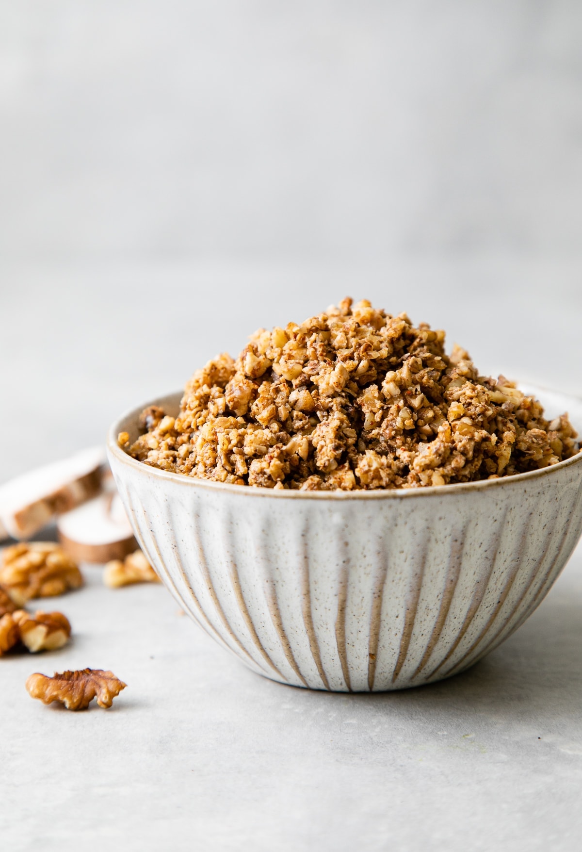 head on view walnut meat in a bowl with items surrounding.