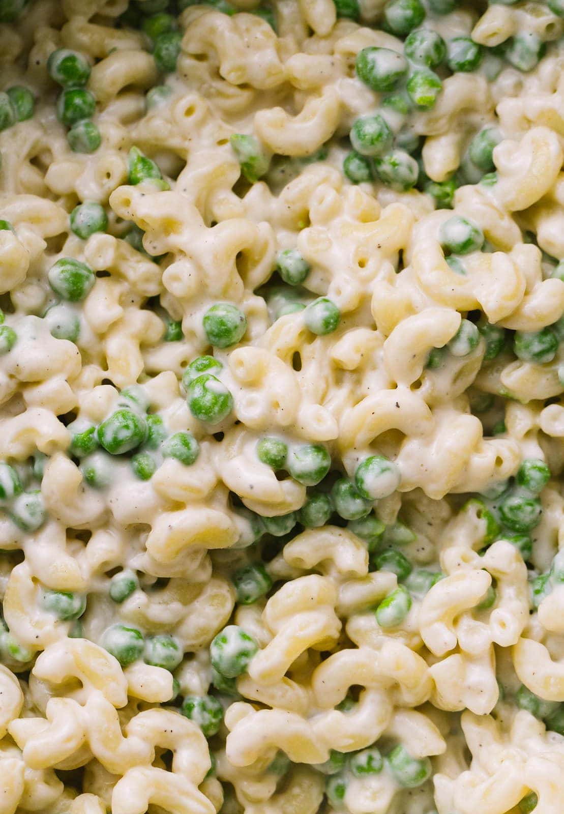 top down, up close view of vegan mac and cheese with peas