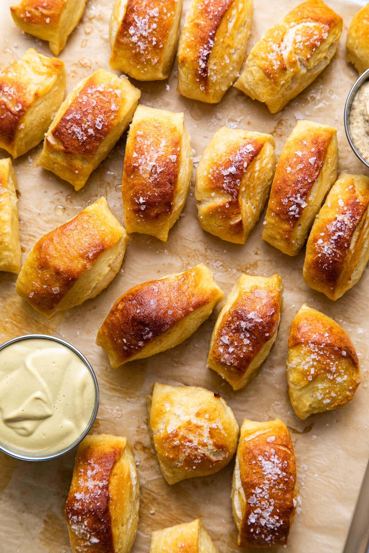 top down view of freshly baked vegan soft pretzel bites on a baking sheet.