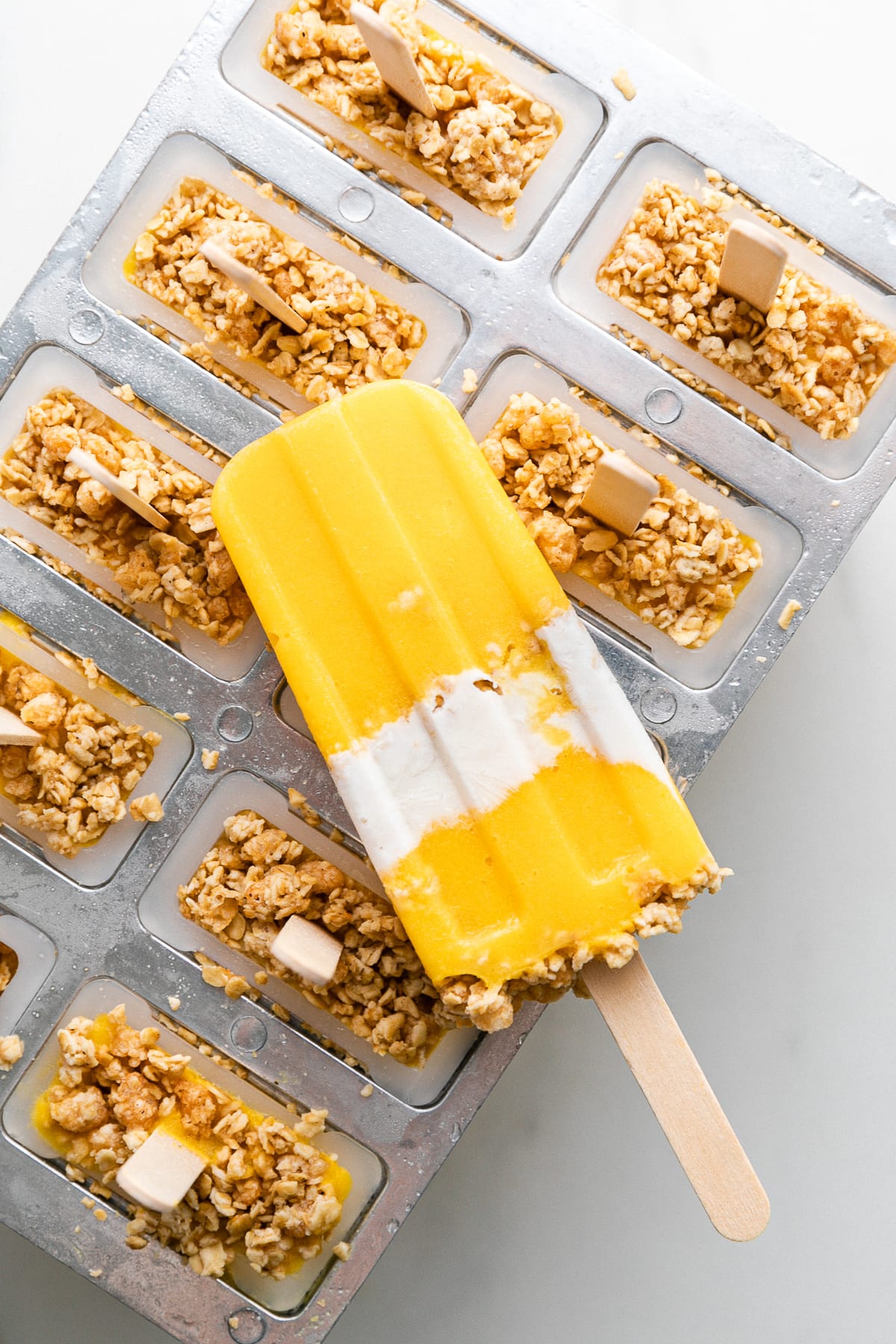 top down view of frozen popsicle resting on top of a popsicle mold.