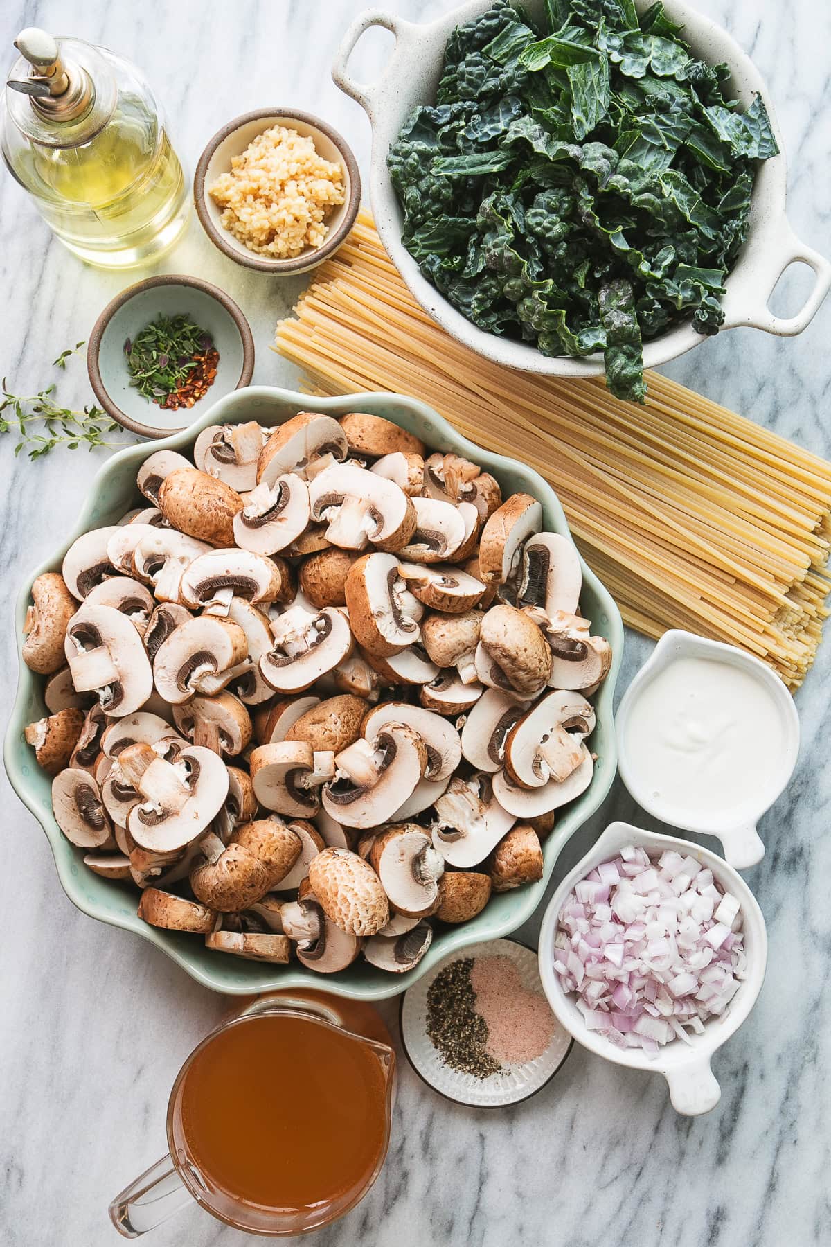 top down view of ingredients to make mushroom kale pasta recipe.