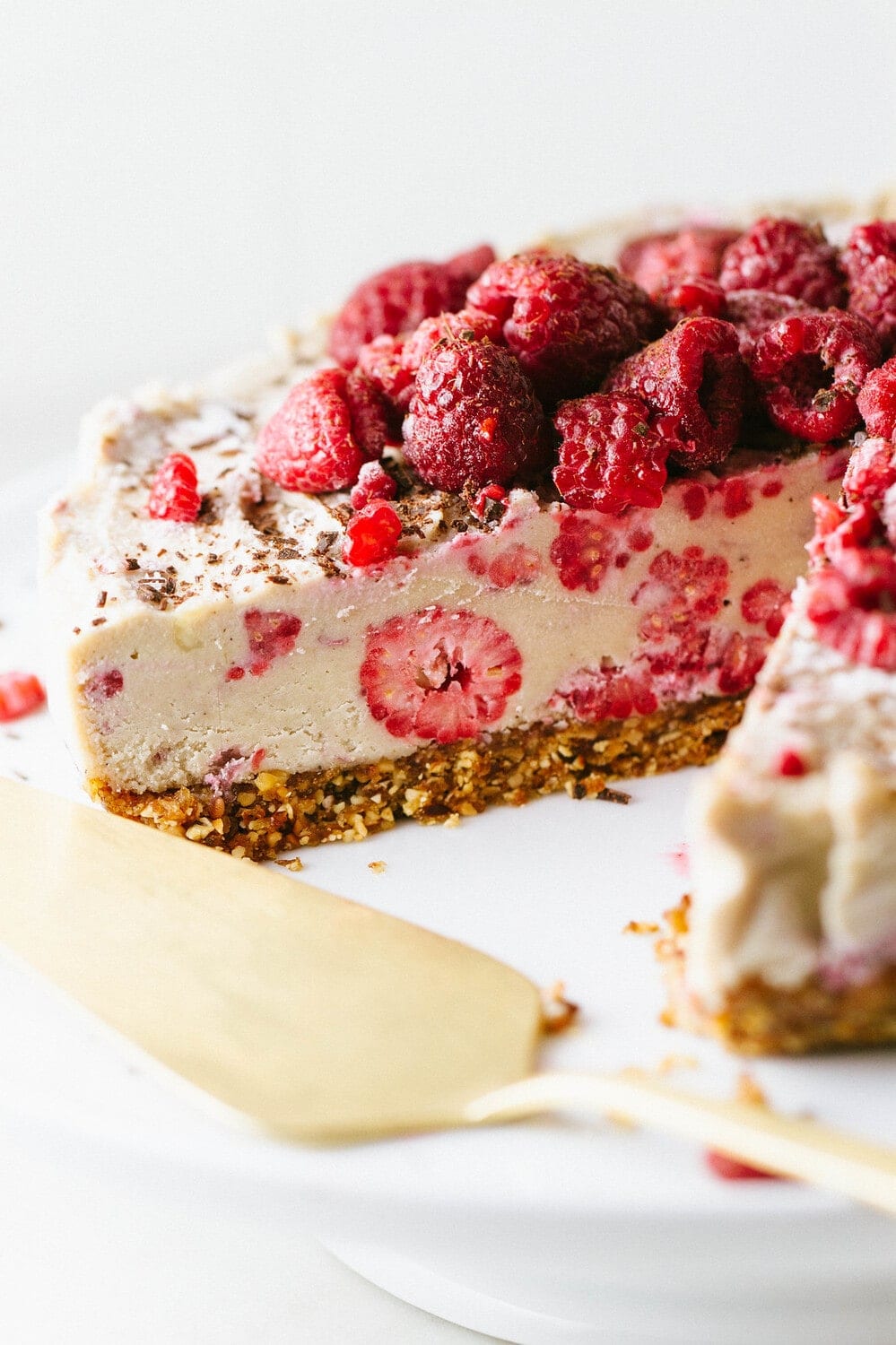 side angle view of no bake vegan cheesecake on a whith