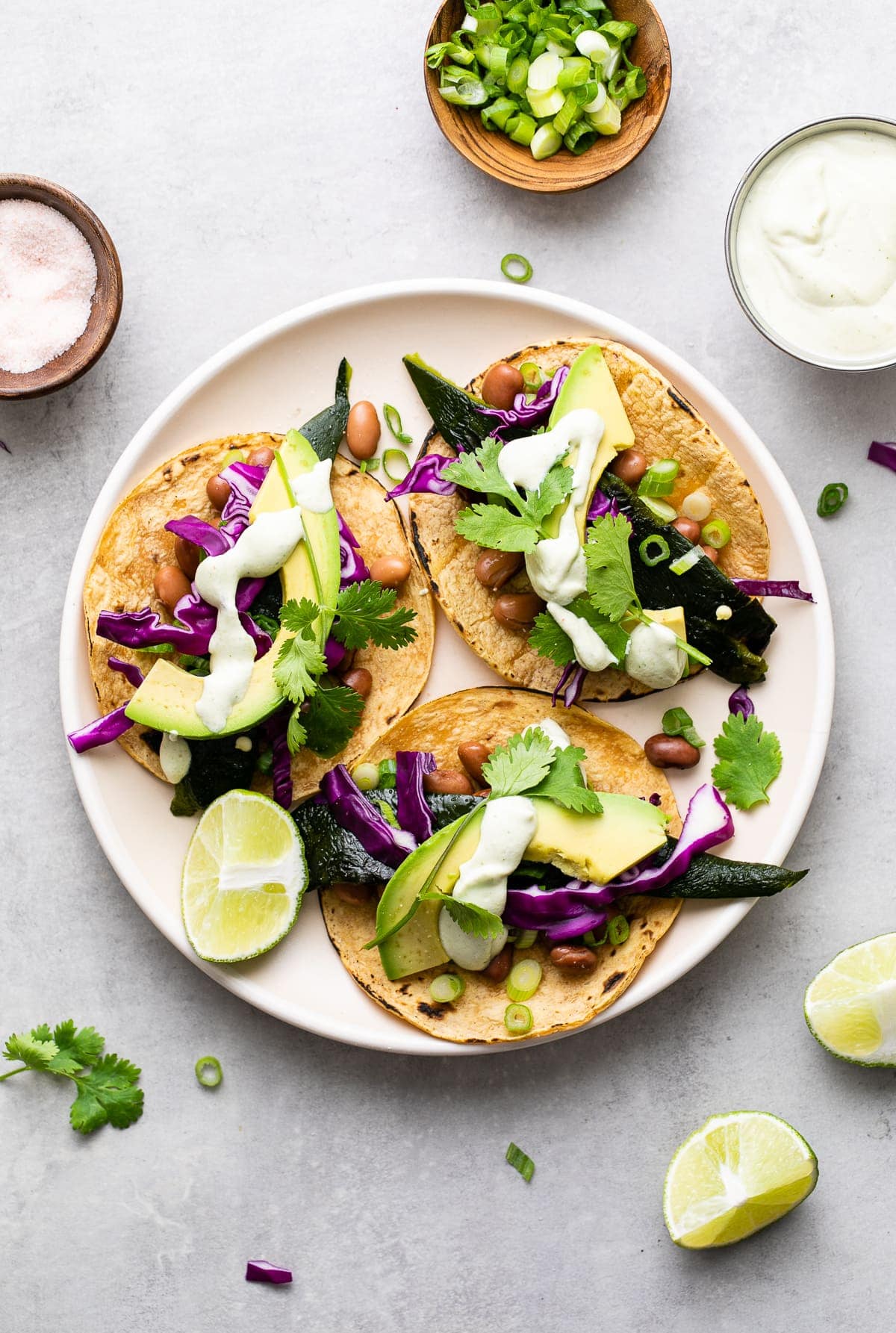 top down view of poblano tacos with crema on a plate.