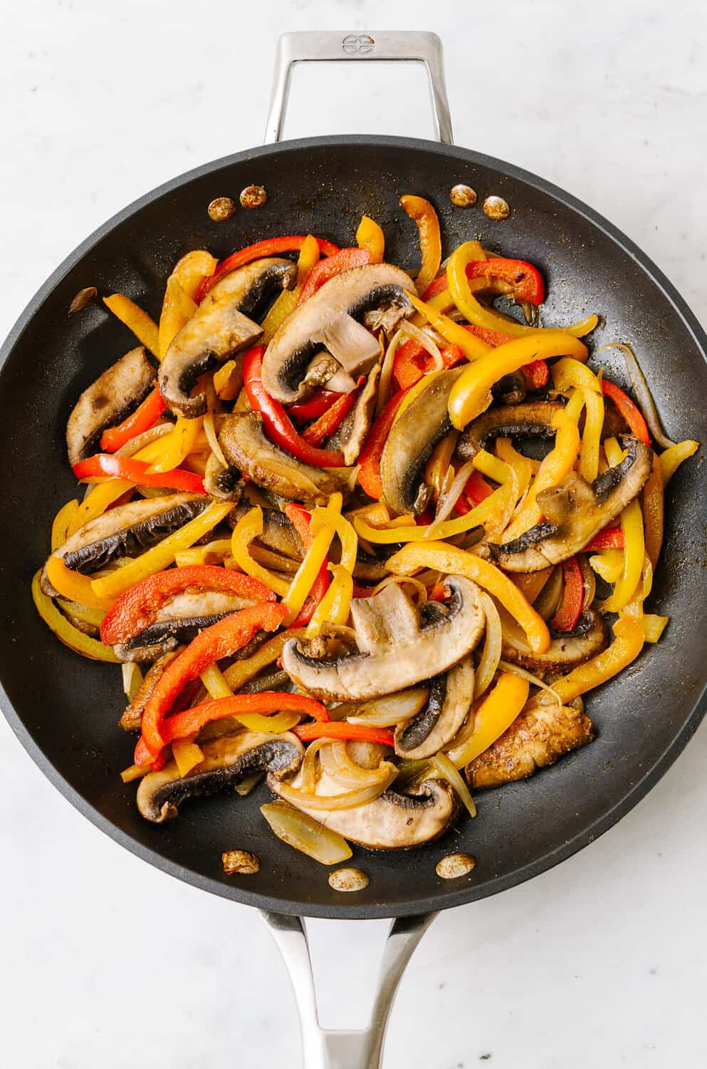 top down view of mushroom fajitas cooked in a skillet.