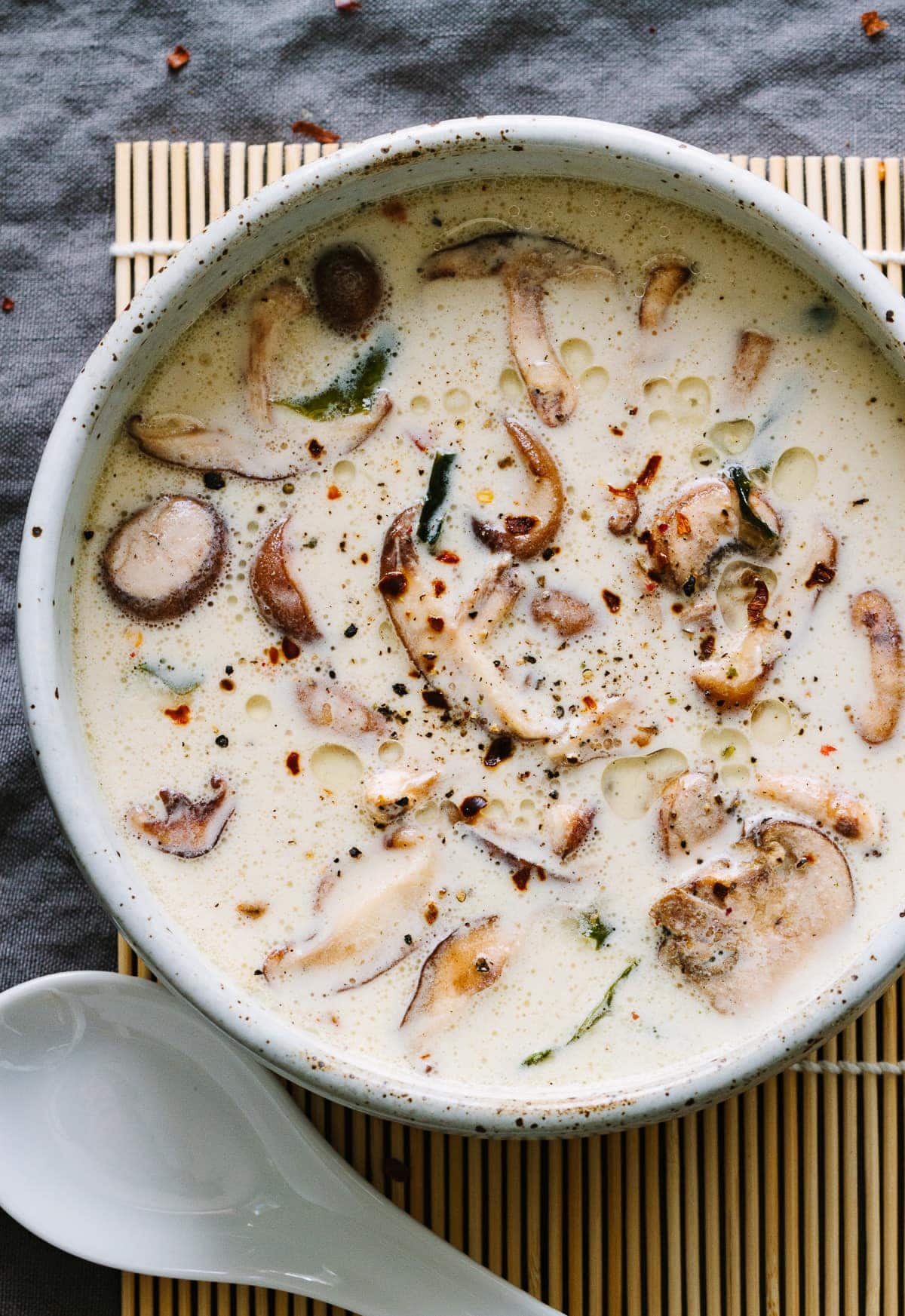 raw creamy miso soup with mushrooms in a rustic handmade bowl with a white spoon
