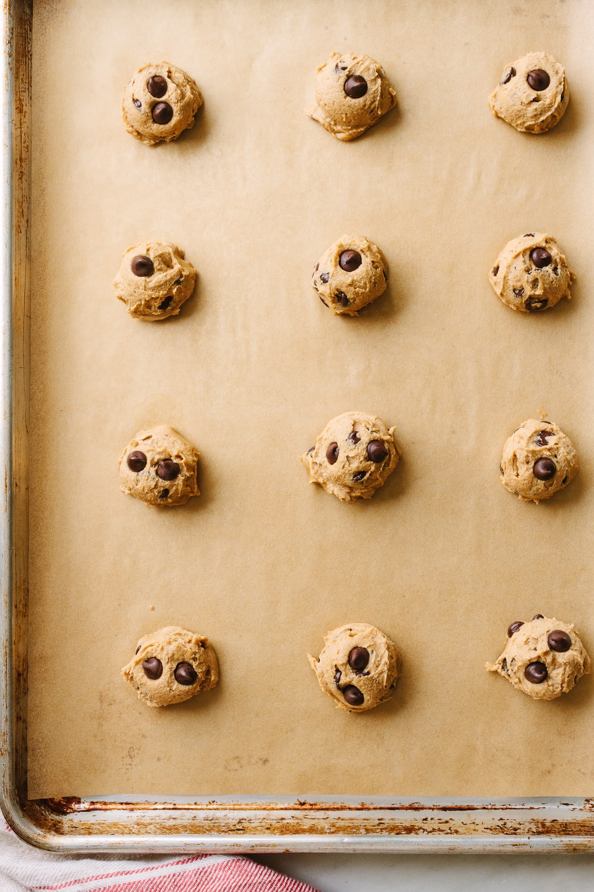 top down view of raw vegan cookie dough mounds on baking sheet.