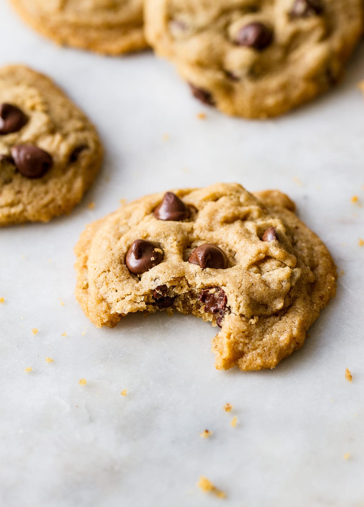 side angle view of chocolate chip cookie with bite taken.